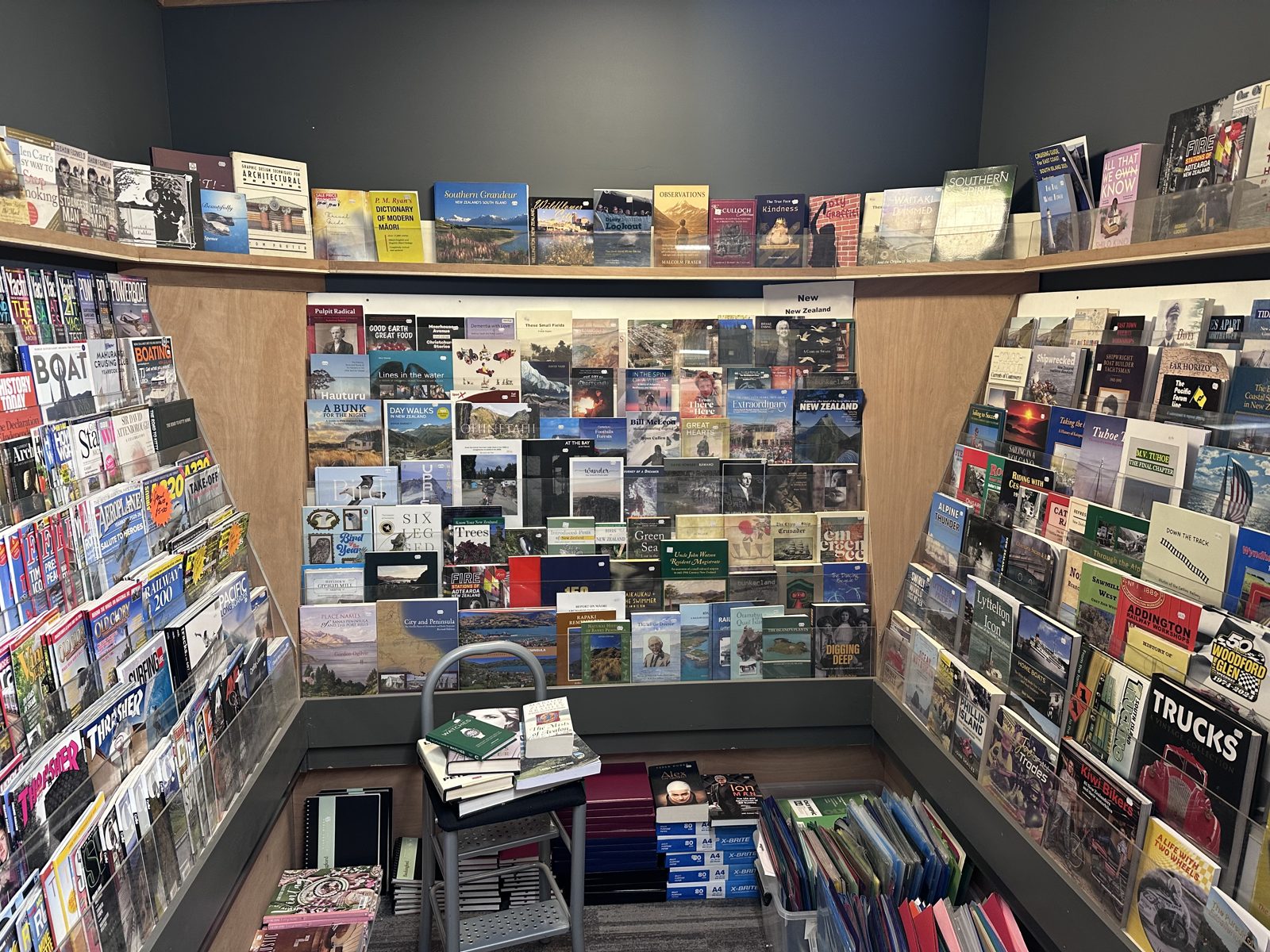 Corner of Leslie’s Bookshop with racks of New Zealand books and magazines